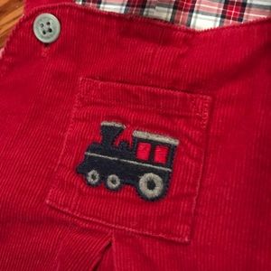 Red corduroy overalls lined with plaid fabric